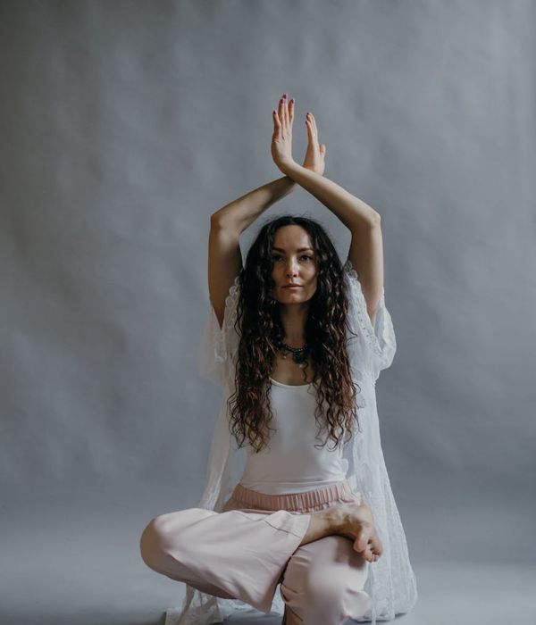 Woman in a graceful stretching pose, feeling calm and focused.